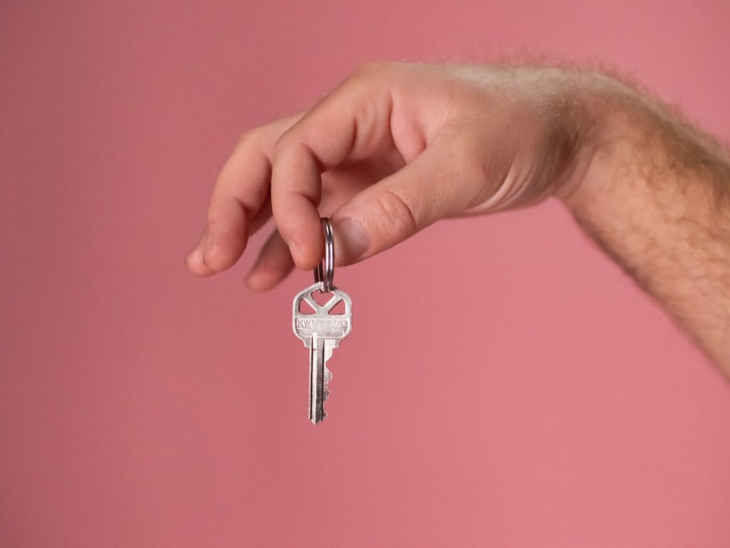 owner hand holding out keys to rent