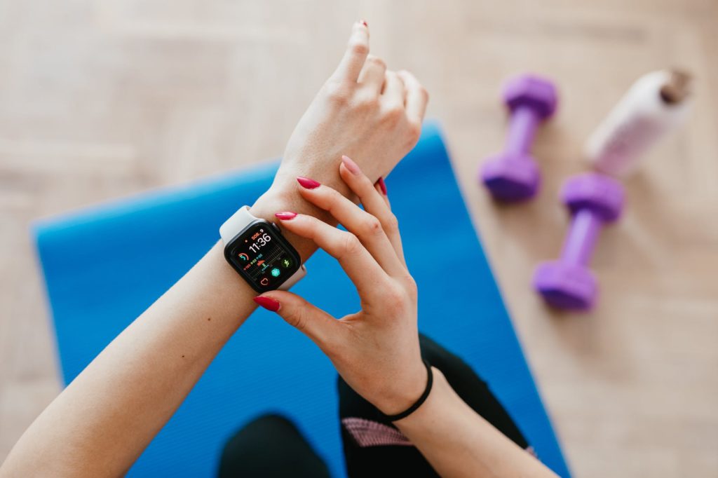 woman adjusting smart watch after workout